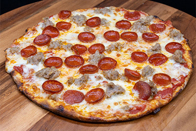 Round Artisanal Pizza with cupped pepperoni and sausage made for takeout near Cherry Hill, New Jersey.