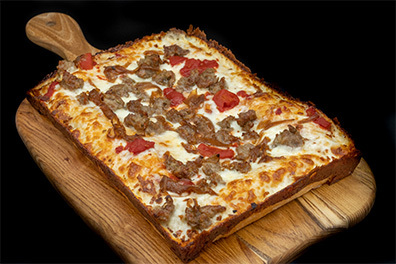 Detroit Style Pizza with pepperoni and sausage prepared for the best pizza takeout near Lawnside, New Jersey.